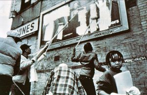 1990 Calvin Butts Defacing Harlem Billboard