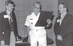Dr. C. Everett Koop presents Drs. Rick Richards and Alan Blum with the Surgeon General's Medallion, 1988