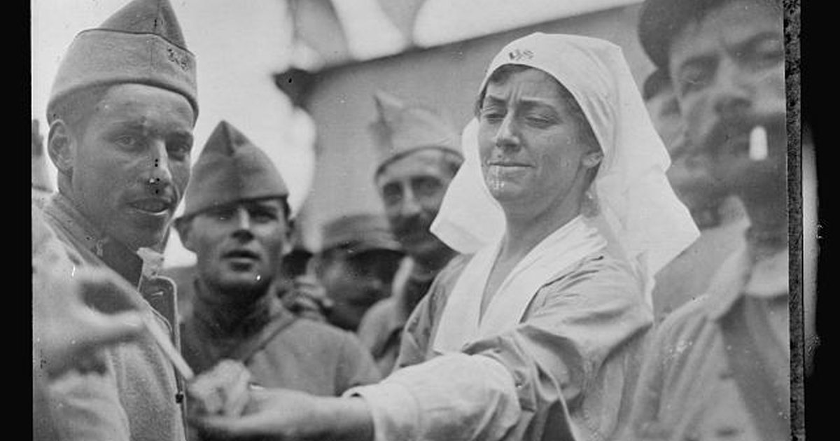 American Red Cross worker distributing cigarettes to soldiers at the A.R.C. Canteen at Orry la Ville