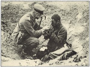 German officer lights the cigarette of a wounded Russian soldier who sought shelter in a hole dug by an exploded shell