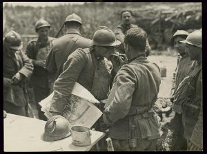 n.d. LOC Army Signal Corps Italian soldier holding illustrated newspaper gets his cigarette lit by another soldier near Piave River Italy
